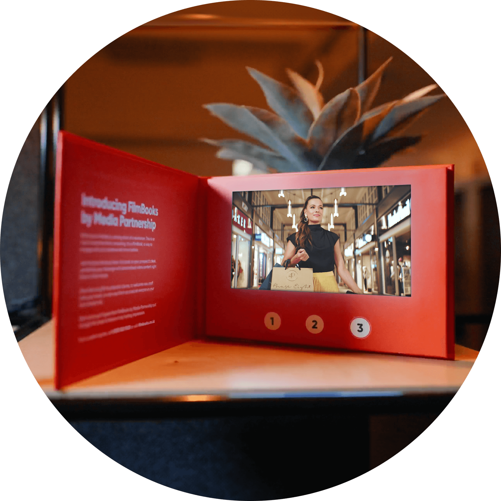 A FilmBooks printed brochure open to show its built-in video screen